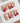 Rock Summer press-on nails in medium coffin shape — Red & White Star French, Silver Charms.