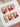 Rock Summer press-on nails in medium coffin shape — Red & White Star French, Silver Charms.
