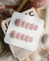 Rose Bead extra short squoval nails with pink shimmer and raised metallic beads