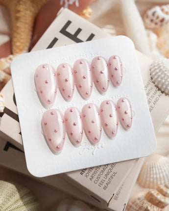 Rose Bead medium almond nails with rose-gold bead dots and soft feminine shimmer