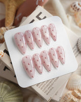 Rose Bead medium stiletto nails with rose-pink bead dots on glossy shimmer