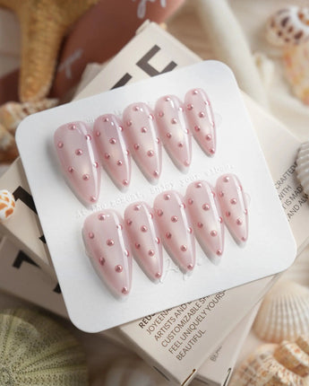 Rose Bead medium stiletto nails with rose-pink bead dots on glossy shimmer