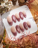 Close-up of Rose Edge press-on nails with rose chrome French tips and 3D baroque swirls