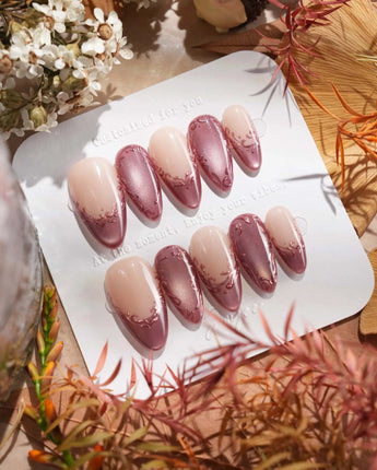 Close-up of Rose Edge press-on nails with rose chrome French tips and 3D baroque swirls