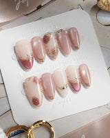 Rose-Théâtre Noir press-on nails in short almond shape — Elegant Rose Pink, Embossed Florals & Metallic Edging.