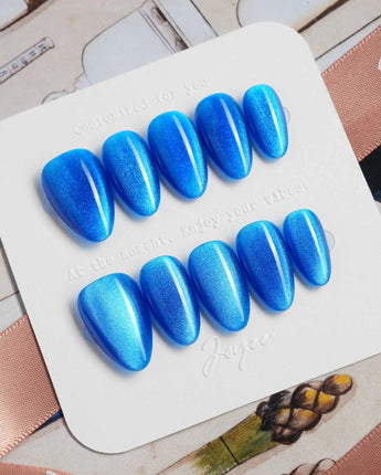 Royal Blue press-on nails in extra short almond shape — Deep Starry Blue, Cat Eye Glossy Effect.