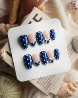 Sailor Dot hand-painted white polka dots on glossy navy press-on nails