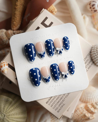 Sailor Dot hand-painted white polka dots on glossy navy press-on nails