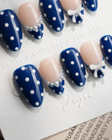 Sailor Dot extra short almond press-on nails with navy polka dots and nude accents