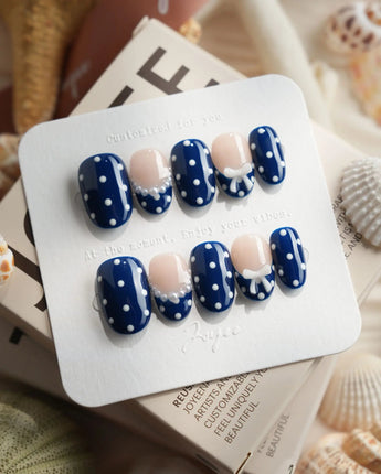 Sailor Dot short oval press-on nails with classic navy polka dot manicure