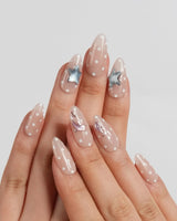 Salt & Sand medium almond nails with metallic ocean charms and warm nude gel