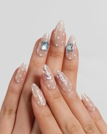 Salt & Sand medium almond nails with metallic ocean charms and warm nude gel