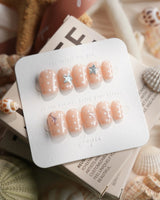 Salt & Sand extra short coffin nails with beach treasure charms on nude gel