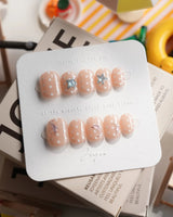 Salt & Sand extra short squoval nails with metallic starfish and sea-foam dots