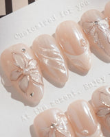 Satin Dress press-on nails in short almond shape — nude pink pearl sheen 3D floral ribbon embossed