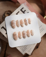 Satin Dress press-on nails in extra short almond shape — nude pink pearl sheen 3D floral ribbon embossed