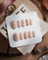 Satin Dress press-on nails in short oval shape — nude pink pearl sheen 3D floral ribbon embossed