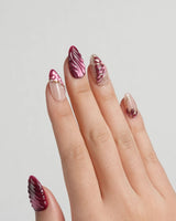 Velvet Flow press-on nails with burgundy cat-eye texture and metallic outlined butterfly wings