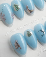 Sea Chrome 3D ocean nails with chrome dolphin, shells, coral, and tiny silver fish