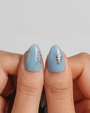 Sea Chrome jewelry-like ocean nail art with chrome starfish, shells, and blue gel base