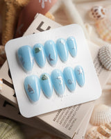Sea Chrome medium almond nails with cornflower-blue gel and 3D chrome sea creatures