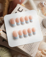 Sea Salt short oval nails with shimmering sky blue French tip design