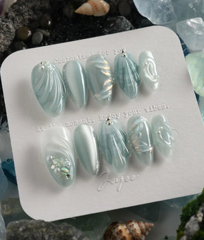Dead Sea Blue handmade almond nails with pearl shell texture and glassy seafoam finish