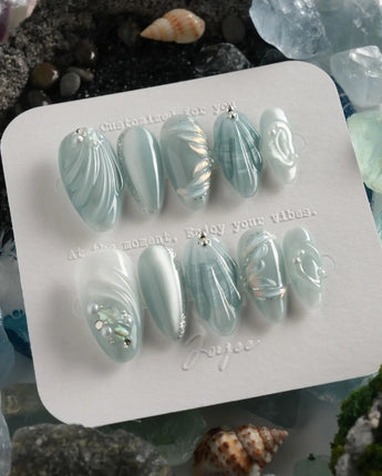 Dead Sea Blue handmade almond nails with pearl shell texture and glassy seafoam finish