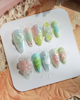 Seaglass Swan cool elegant nails with pastel sea-glass glow and raised floral accents