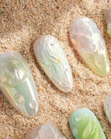 Seaglass Swan translucent blue-green nails with iridescent pastels, 3D florals, and swan motif