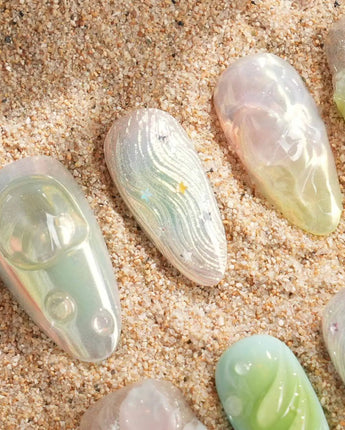 Seaglass Swan translucent blue-green nails with iridescent pastels, 3D florals, and swan motif
