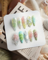 Seaglass Swan medium stiletto nails with iridescent pastels, florals, and swan motif