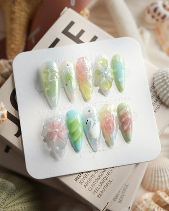 Seaglass Swan medium stiletto nails with iridescent pastels, florals, and swan motif