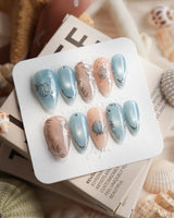 Shell Money medium almond nails with heirloom silver seashell and pearl accents