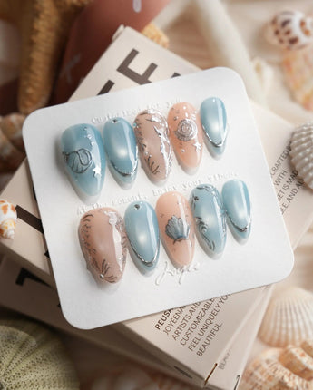 Shell Money medium almond nails with heirloom silver seashell and pearl accents