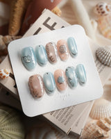 Shell Money medium oval nails with silver shell sculpture and dusty blue nude palette