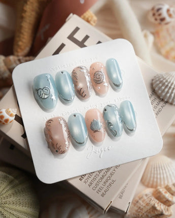 Shell Money medium oval nails with silver shell sculpture and dusty blue nude palette
