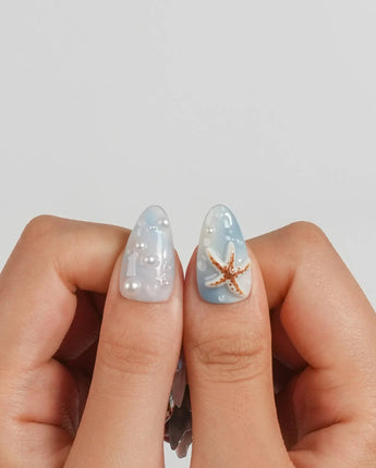 Shell Picking handmade blue jelly nails with aurora shimmer and scattered sea charms