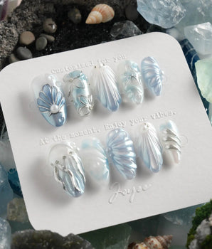 Great Barrier Blue deep-sea nails with pearlescent shell texture and flowing silver waves