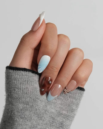 Shore Blend short almond nail set with warm nude, creamy white, and dark rock tones