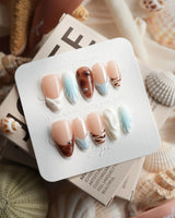 Shore Blend coastal color-block press-on nails with nude, brown, blue, and cream sections