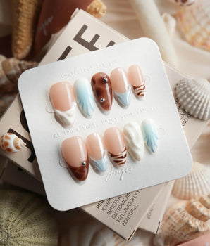 Shore Blend coastal color-block press-on nails with nude, brown, blue, and cream sections