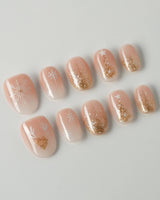 Silent Night press-on nails in extra short oval shape — Champagne Gold Glitter, Christmas Reindeer & Snowflakes.