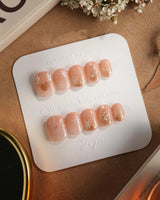 Silent Night press-on nails in extra short squoval shape — Champagne Gold Glitter, Christmas Reindeer & Snowflakes.