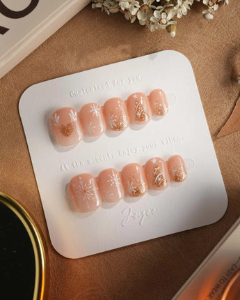 Silent Night press-on nails in extra short squoval shape — Champagne Gold Glitter, Christmas Reindeer & Snowflakes.