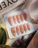 Silent Night press-on nails in medium stiletto shape — Champagne Gold Glitter, Christmas Reindeer & Snowflakes.