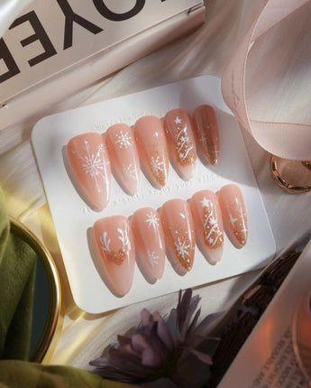 Silent Night press-on nails in medium stiletto shape — Champagne Gold Glitter, Christmas Reindeer & Snowflakes.
