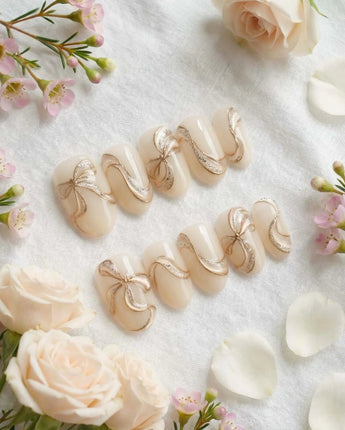Silk Bow press-on nails in short oval shape — Luxury Creamy White & Gold, 3D Champagne Gold Wire Bows & Fine Shimmer.