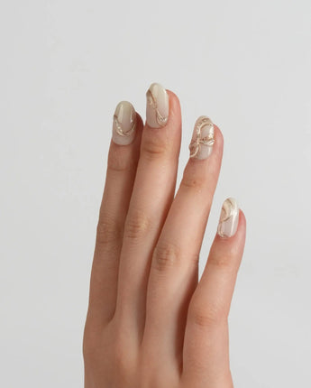 Silk Bow nail art close-up showing Luxury Creamy White & Gold, 3D Champagne Gold Wire Bows & Fine Shimmer. details