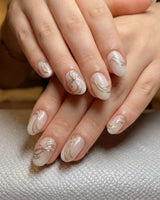 Silk Bow press-on nails in short oval shape — Luxury Creamy White & Gold, 3D Champagne Gold Wire Bows & Fine Shimmer.